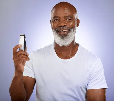 bald man holding a beard trimmer