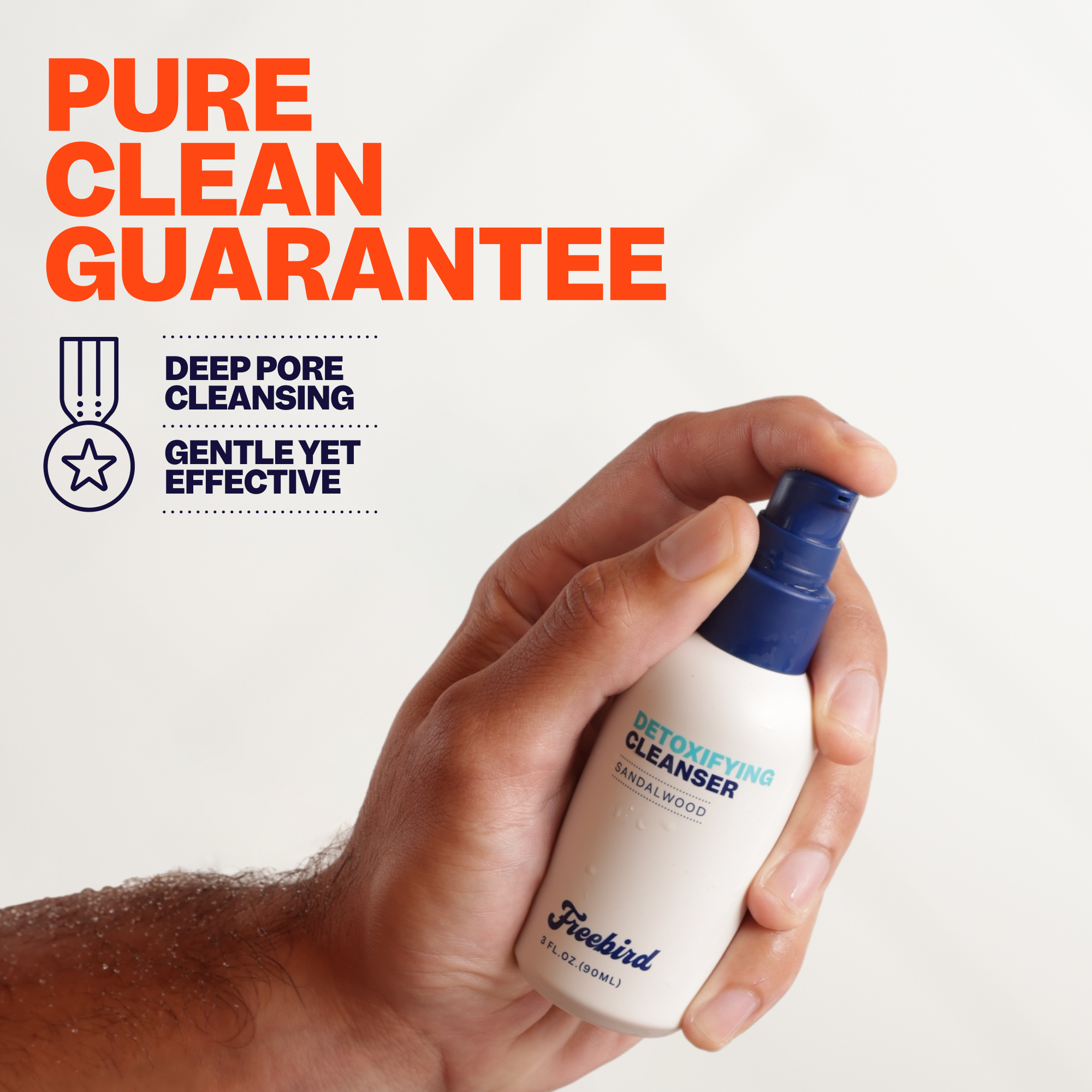 A hand holds Freebirds Detoxifying Bald Head Cleanser, emphasizing its gentle yet effective deep pore purifying experience.