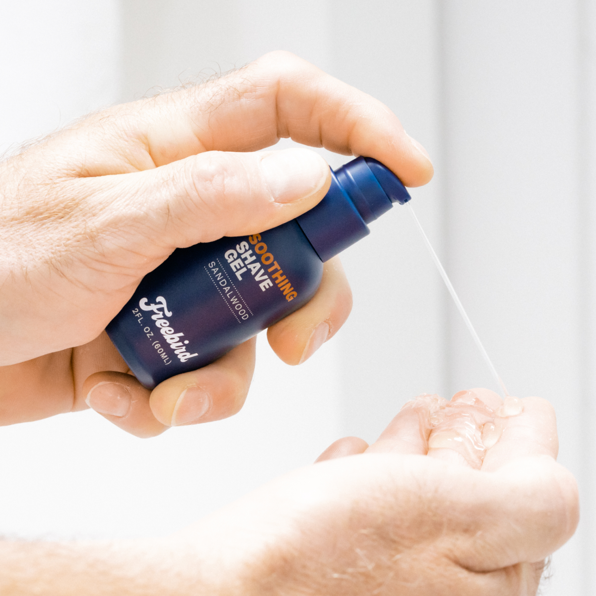 The person applies gel from a blue bottle labeled 